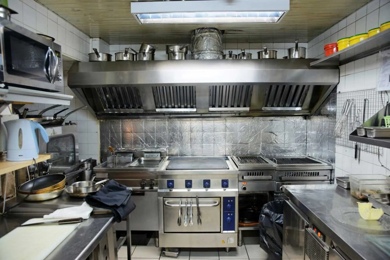 Professional hood cleaning technician servicing a restaurant exhaust system in Portland
